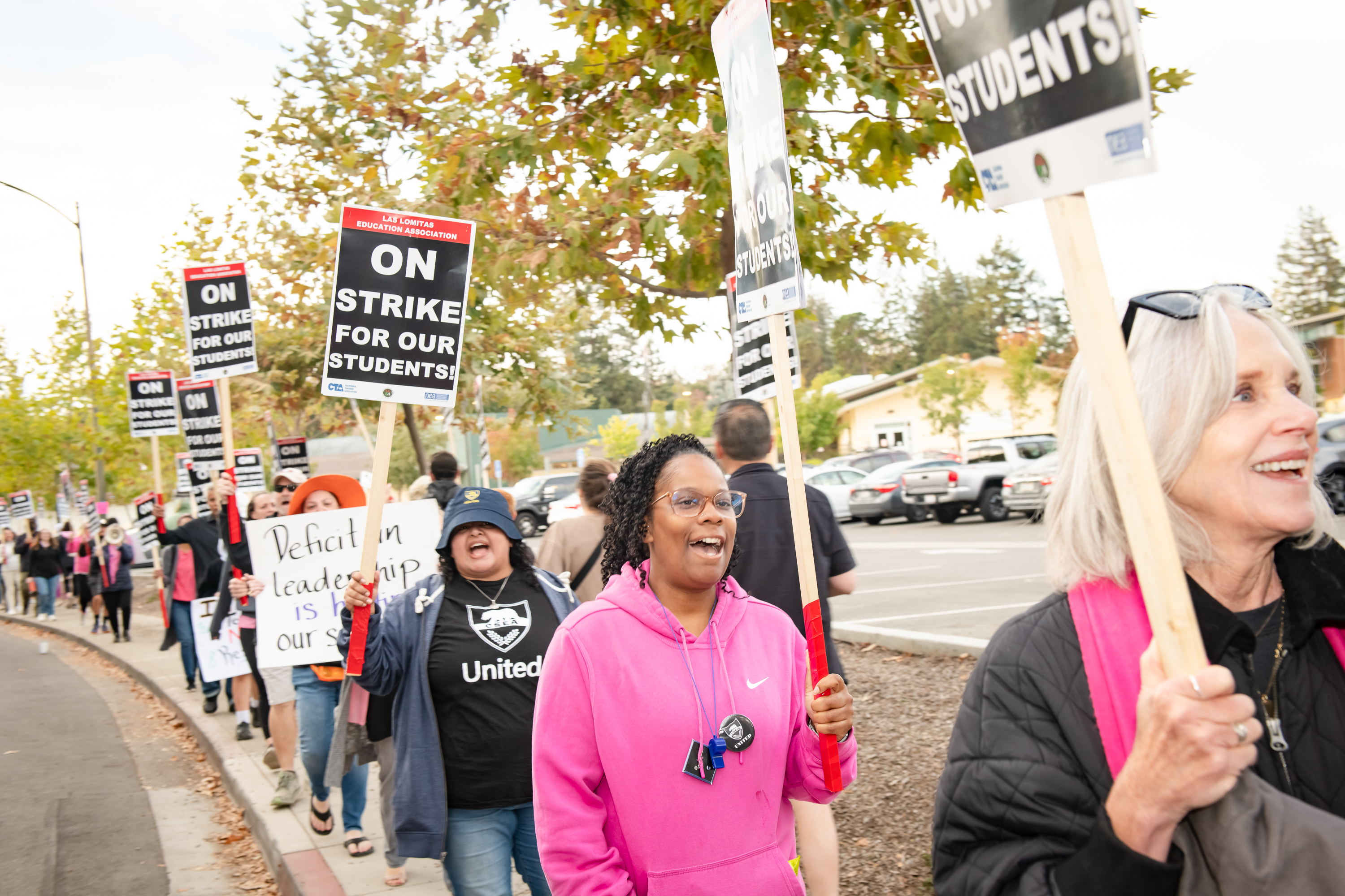 Las Lomitas educators carry signs.