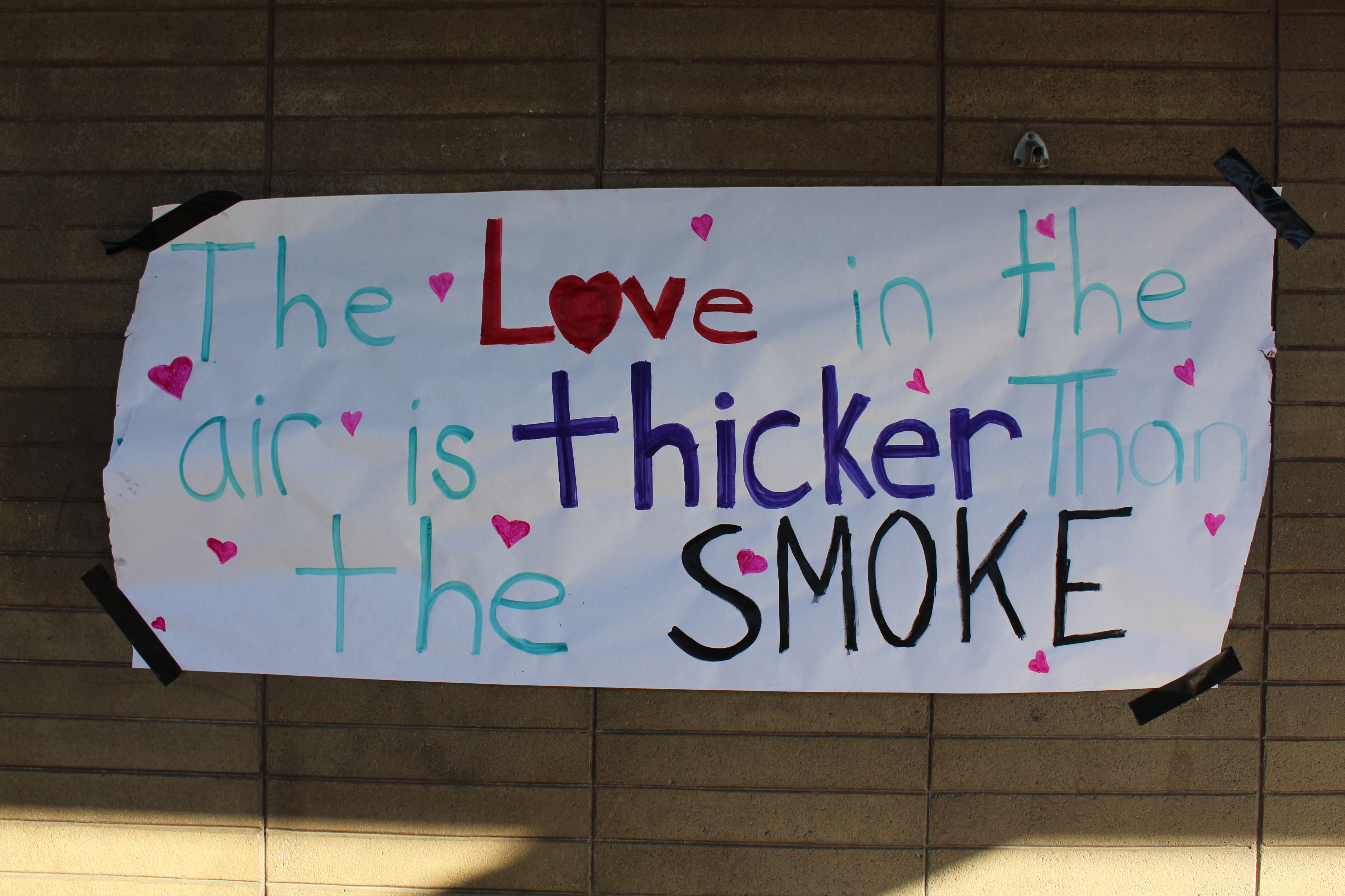 School sign of the times: “The love in the air is thicker than the smoke.”
