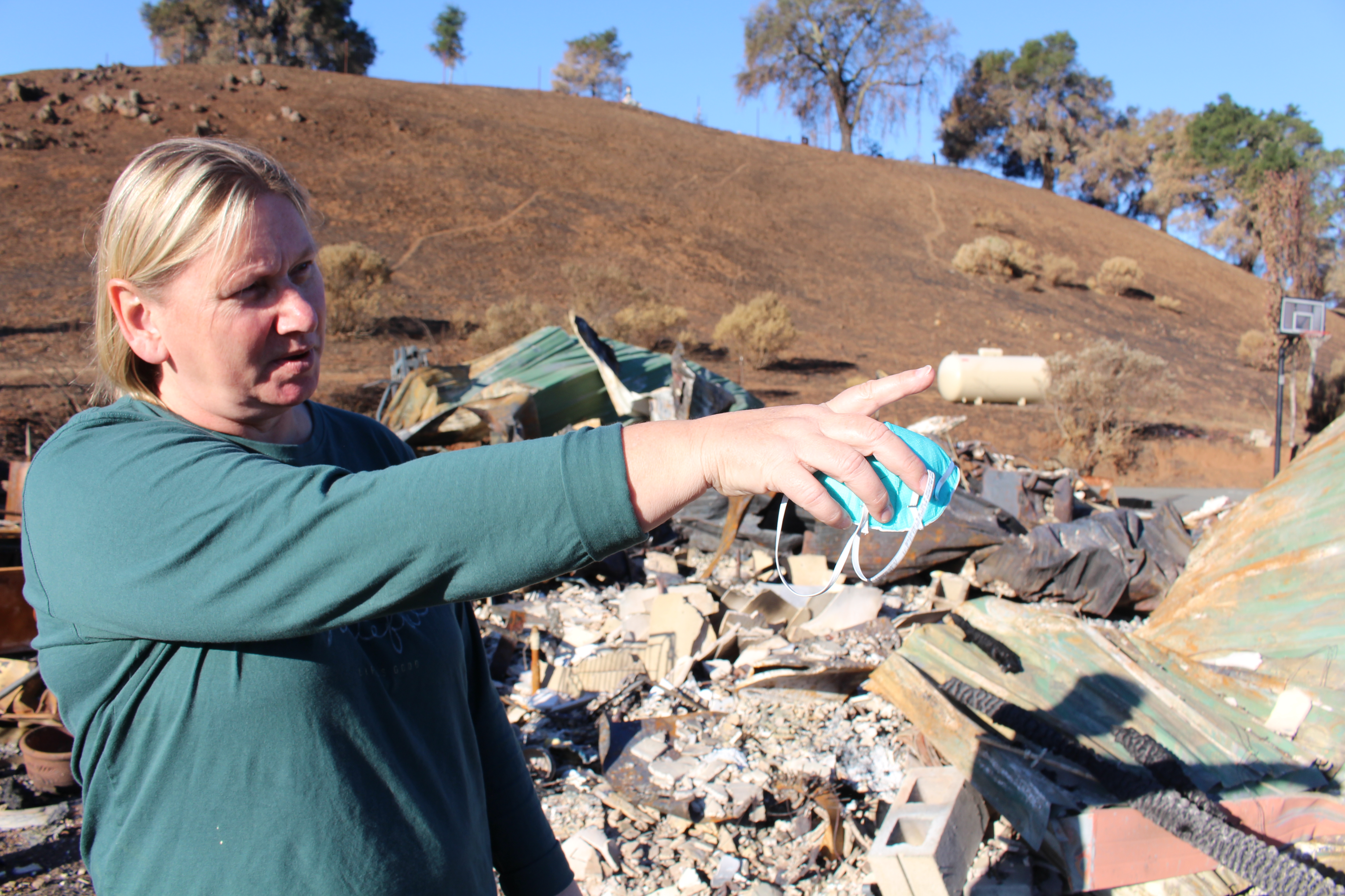 Teacher Cati Day points to damage in her dream home in hills above Santa Rosa.